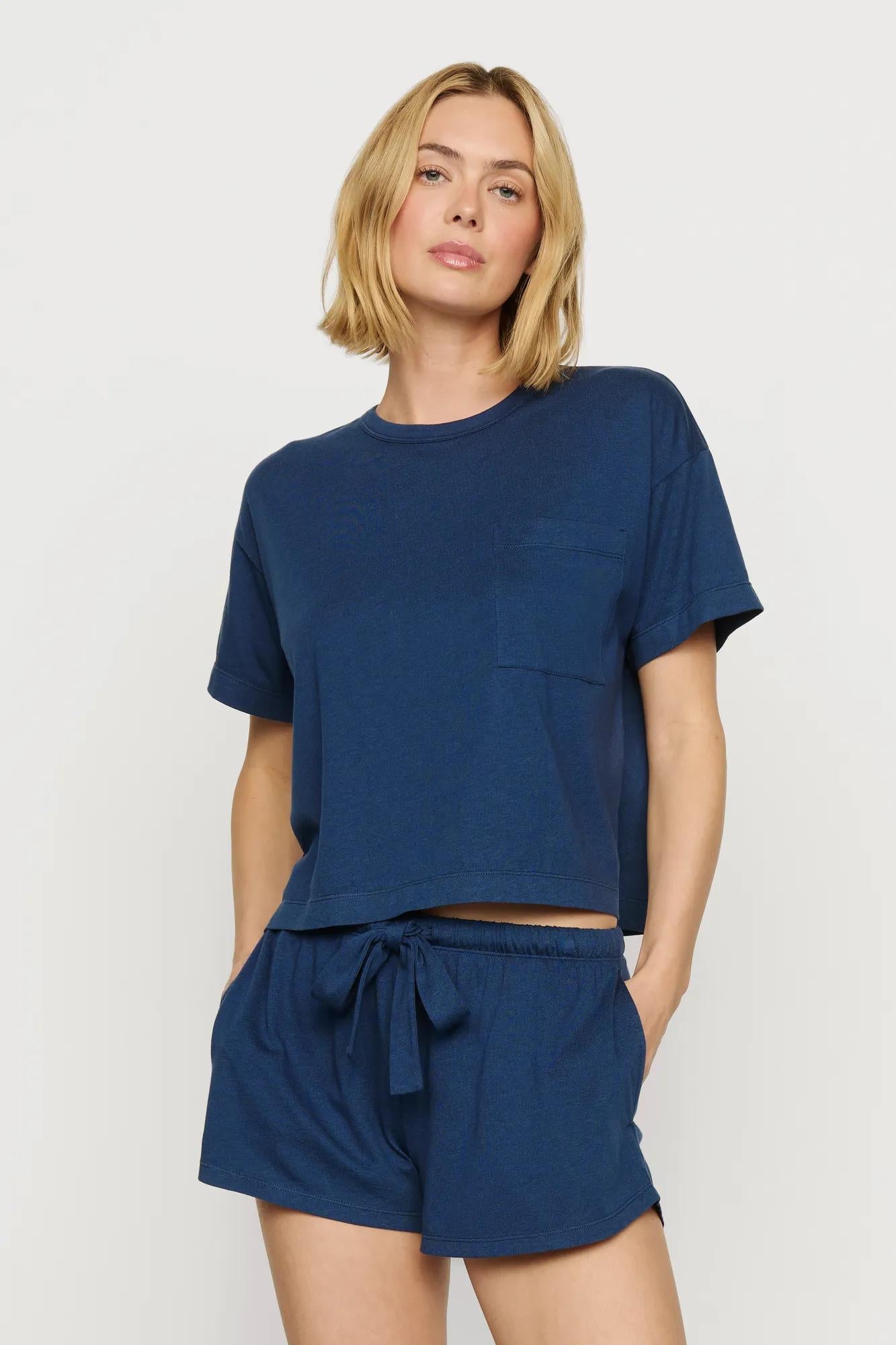 Model is wearing Aloe Cotton Short Sleeve Tee in Navy