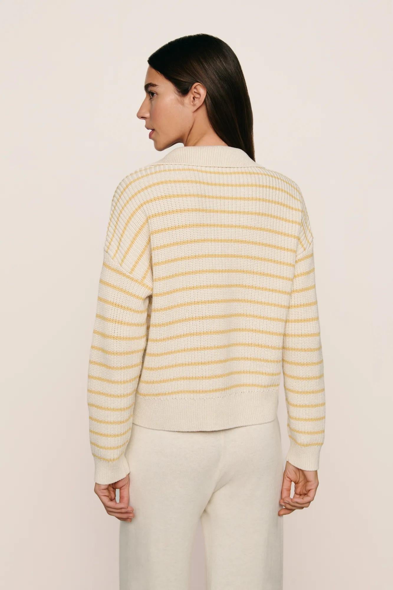 Model is wearing Coastal Cotton Sweater Polo in Stripe Almond Heather/Sunbeam