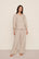 Model is wearing Linen Blend Relaxed Quarter Sleeve Top in Gingham White/Warm Taupe