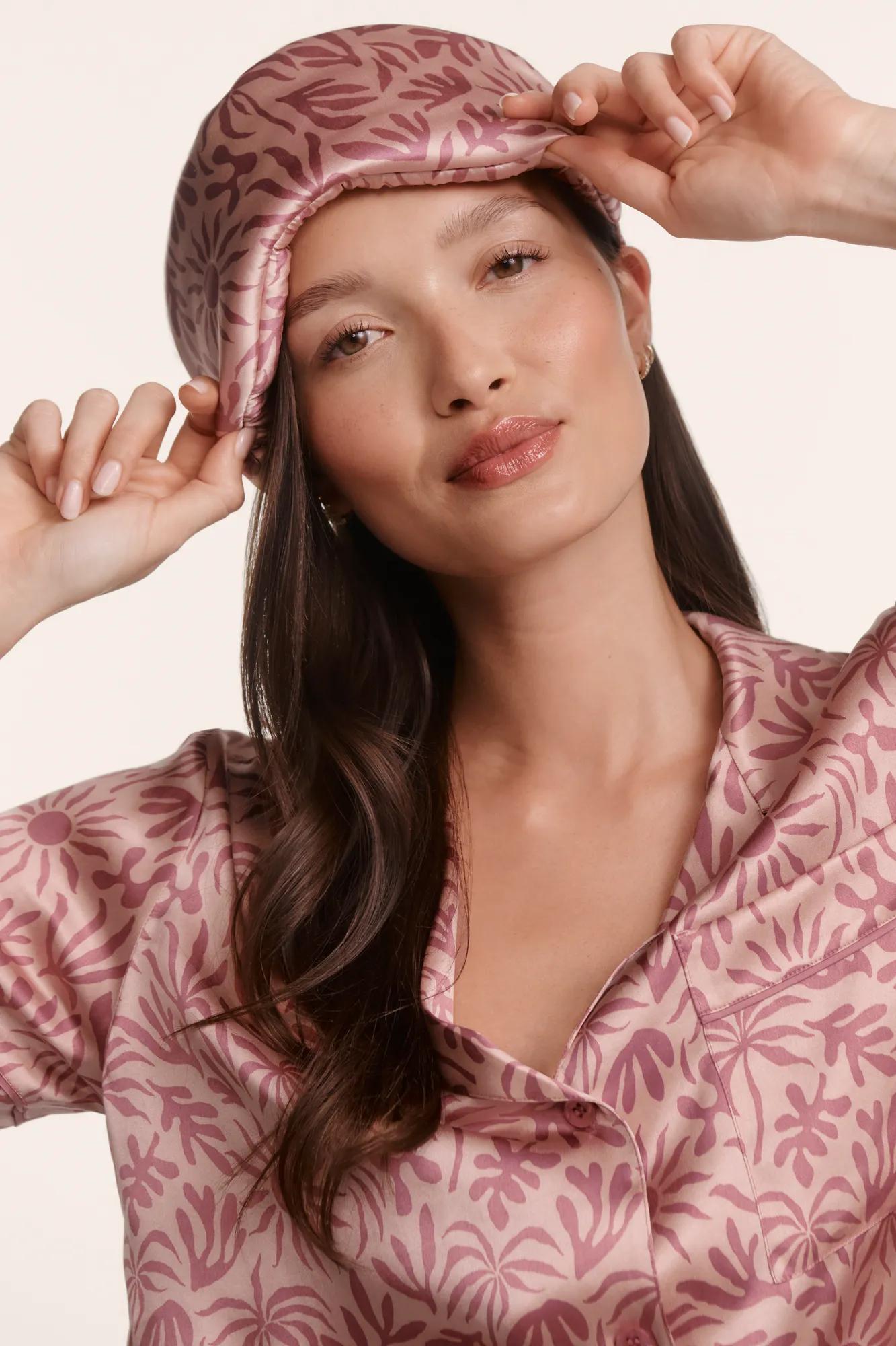 Model is wearing Inez Washable Silk Printed Eye Mask in Bloomscape Misty Rose/Mesa Rose