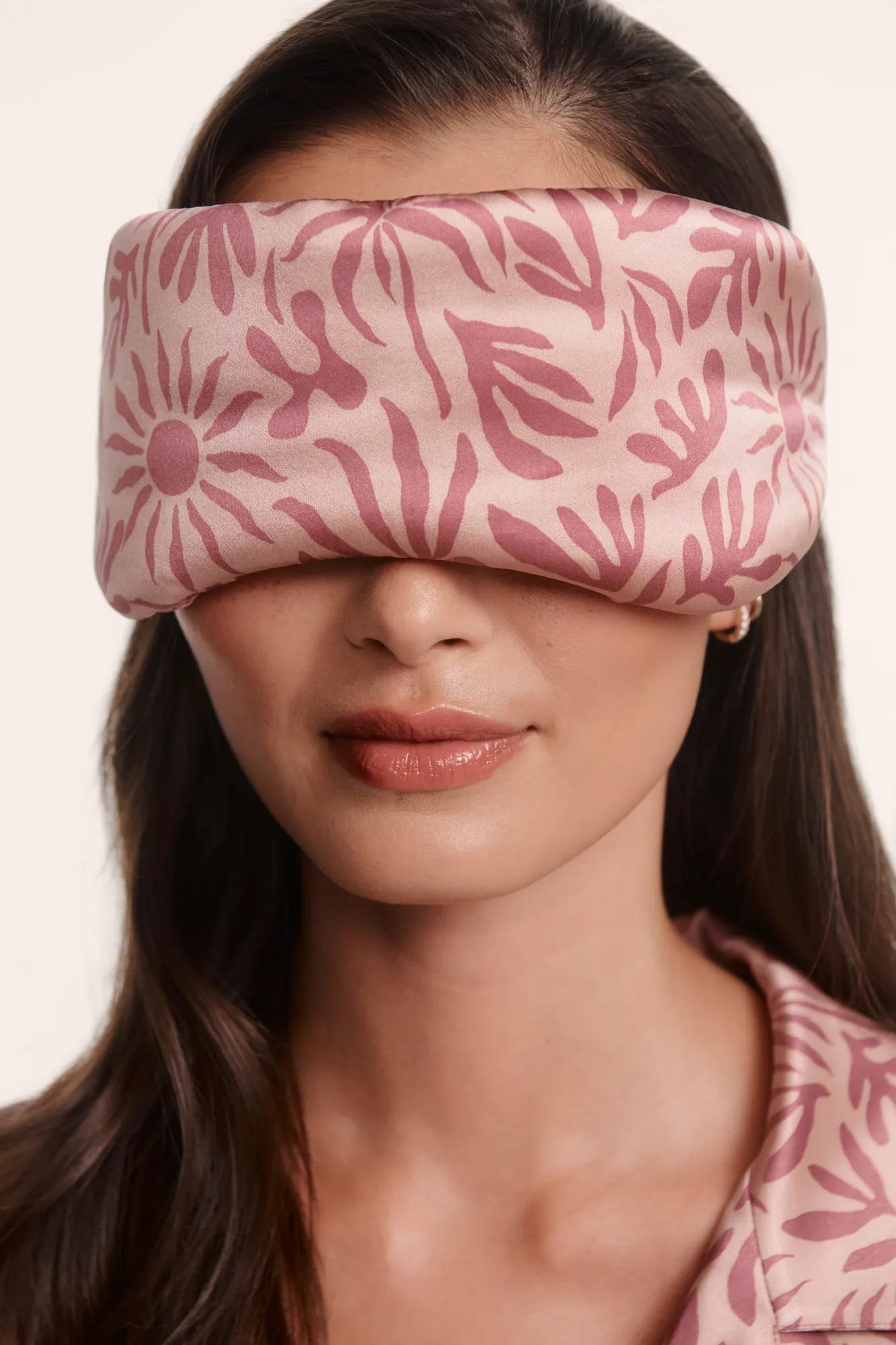 Model is wearing Inez Washable Silk Printed Eye Mask in Bloomscape Misty Rose/Mesa Rose