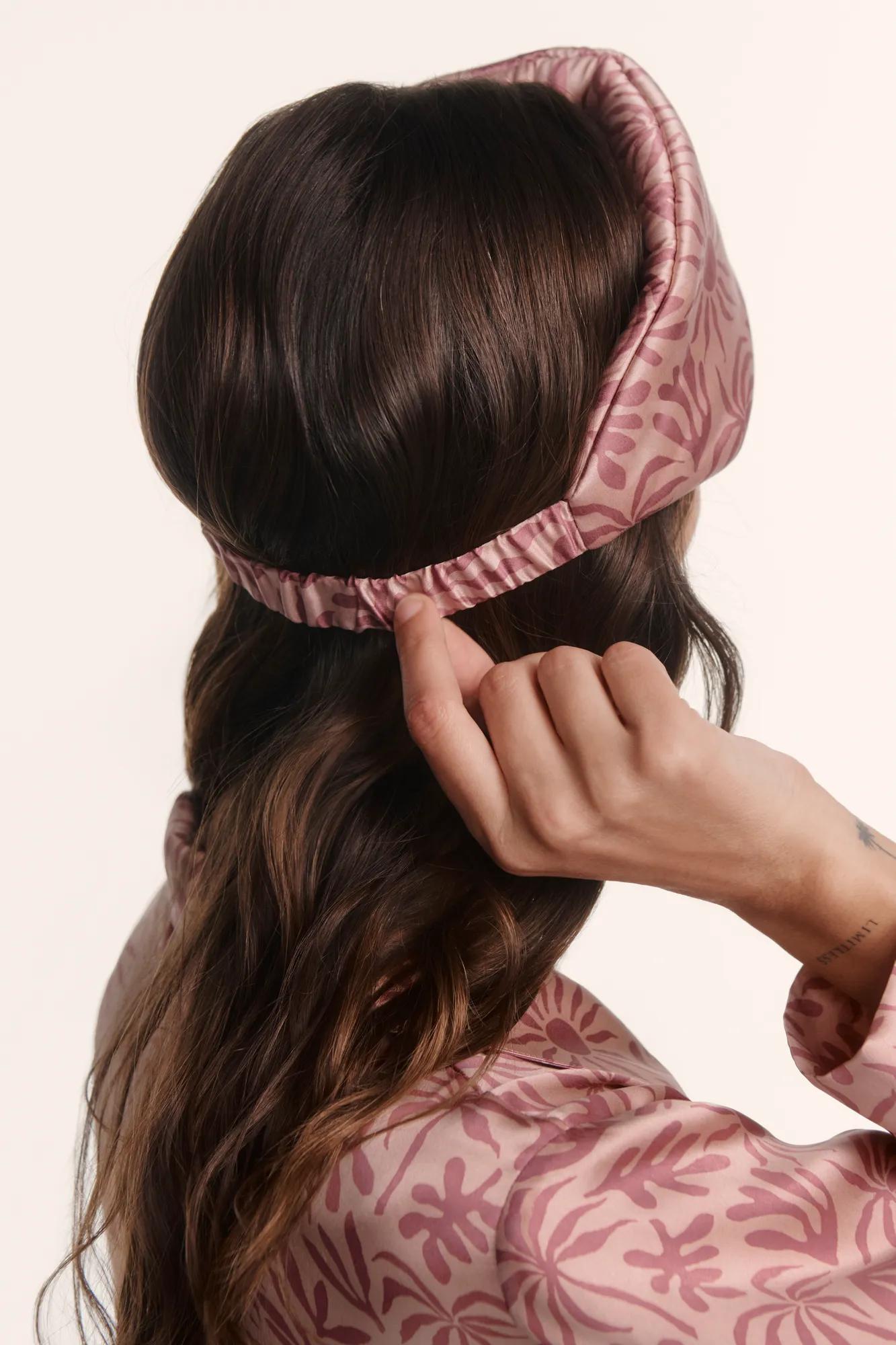 Model is wearing Inez Washable Silk Printed Eye Mask in Bloomscape Misty Rose/Mesa Rose