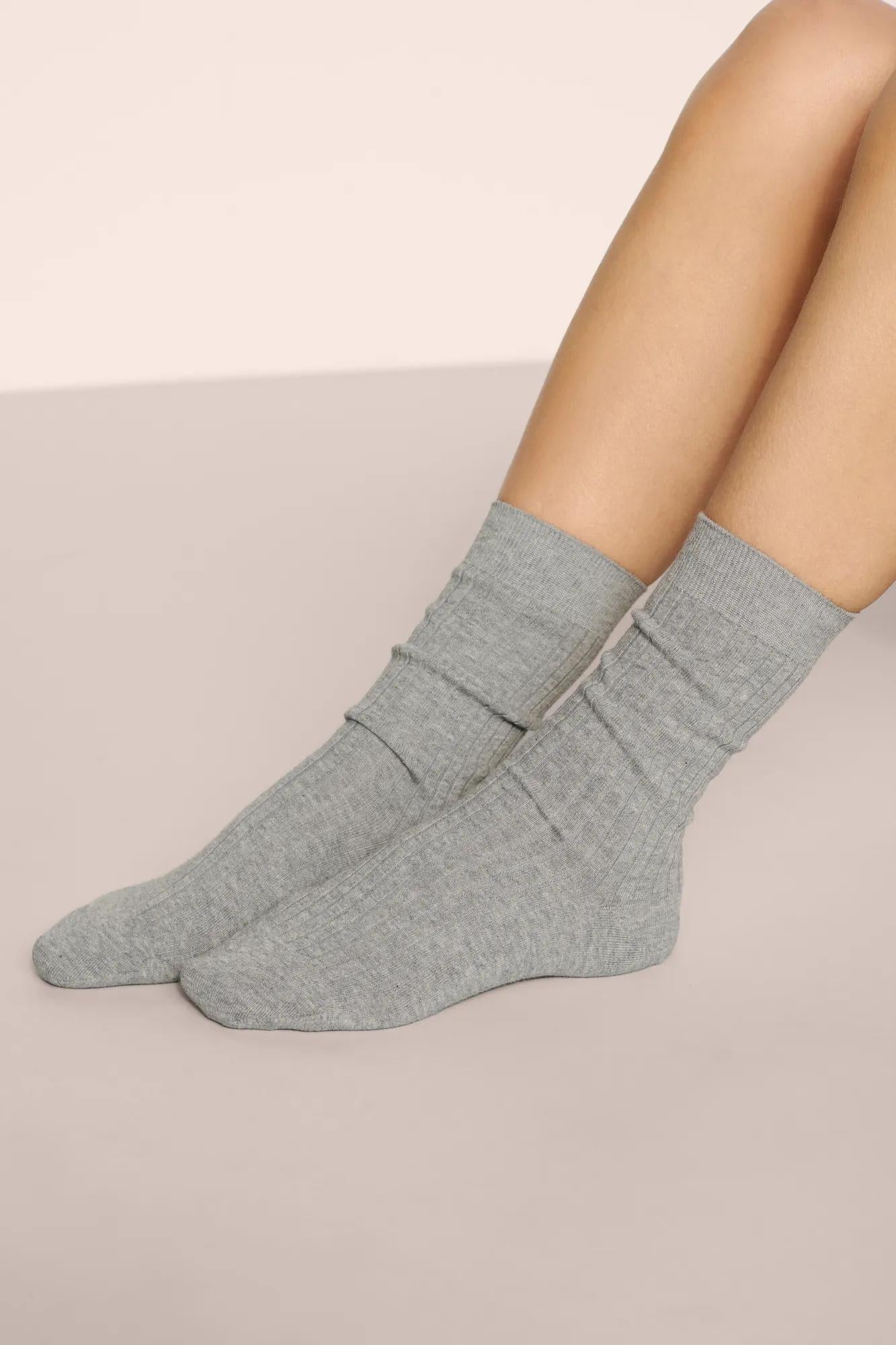 Model is wearing Essential Rib Socks in Dark Heather Grey
