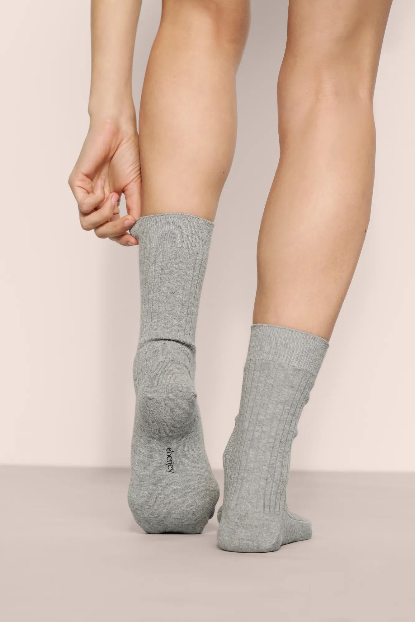 Model is wearing Essential Rib Socks in Dark Heather Grey