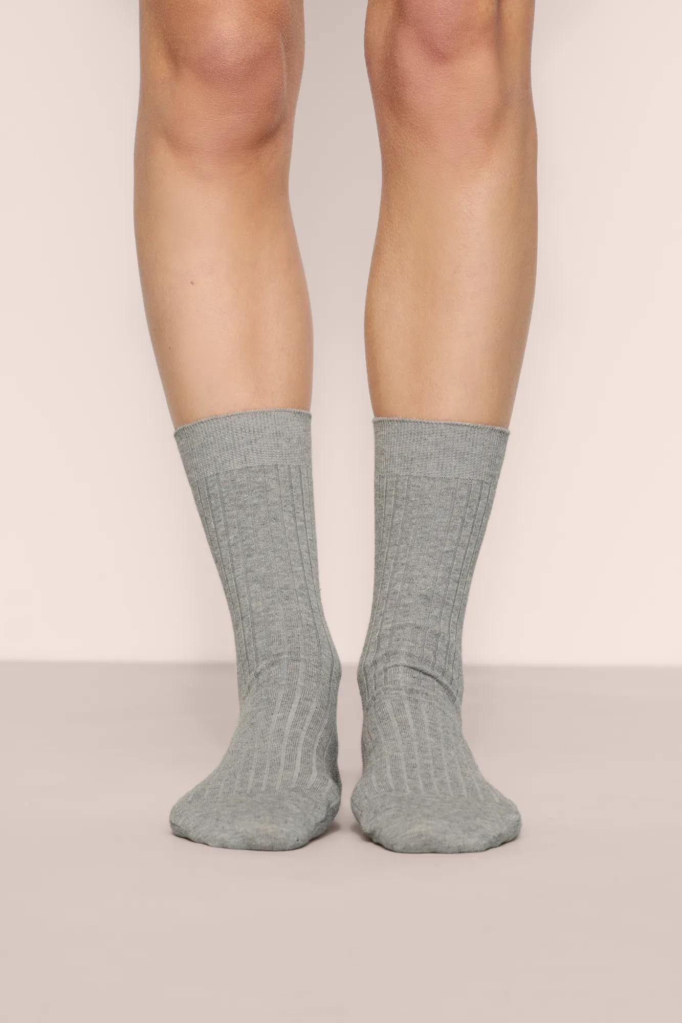 Model is wearing Essential Rib Socks in Dark Heather Grey