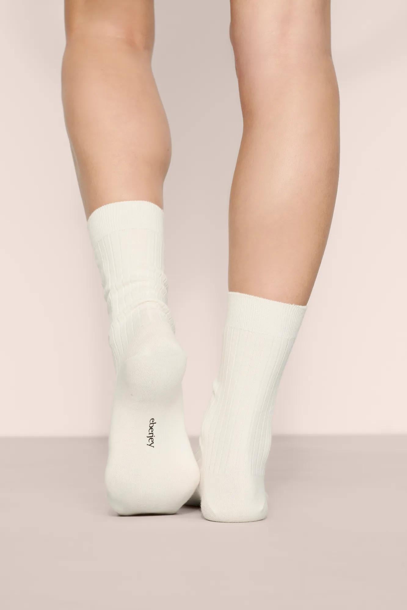 Model is wearing Essential Rib Socks in Ivory