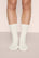 Model is wearing Essential Rib Socks in Ivory