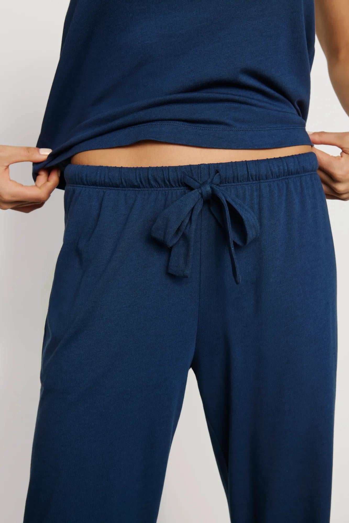 Model is wearing Aloe Cotton Pant in Navy