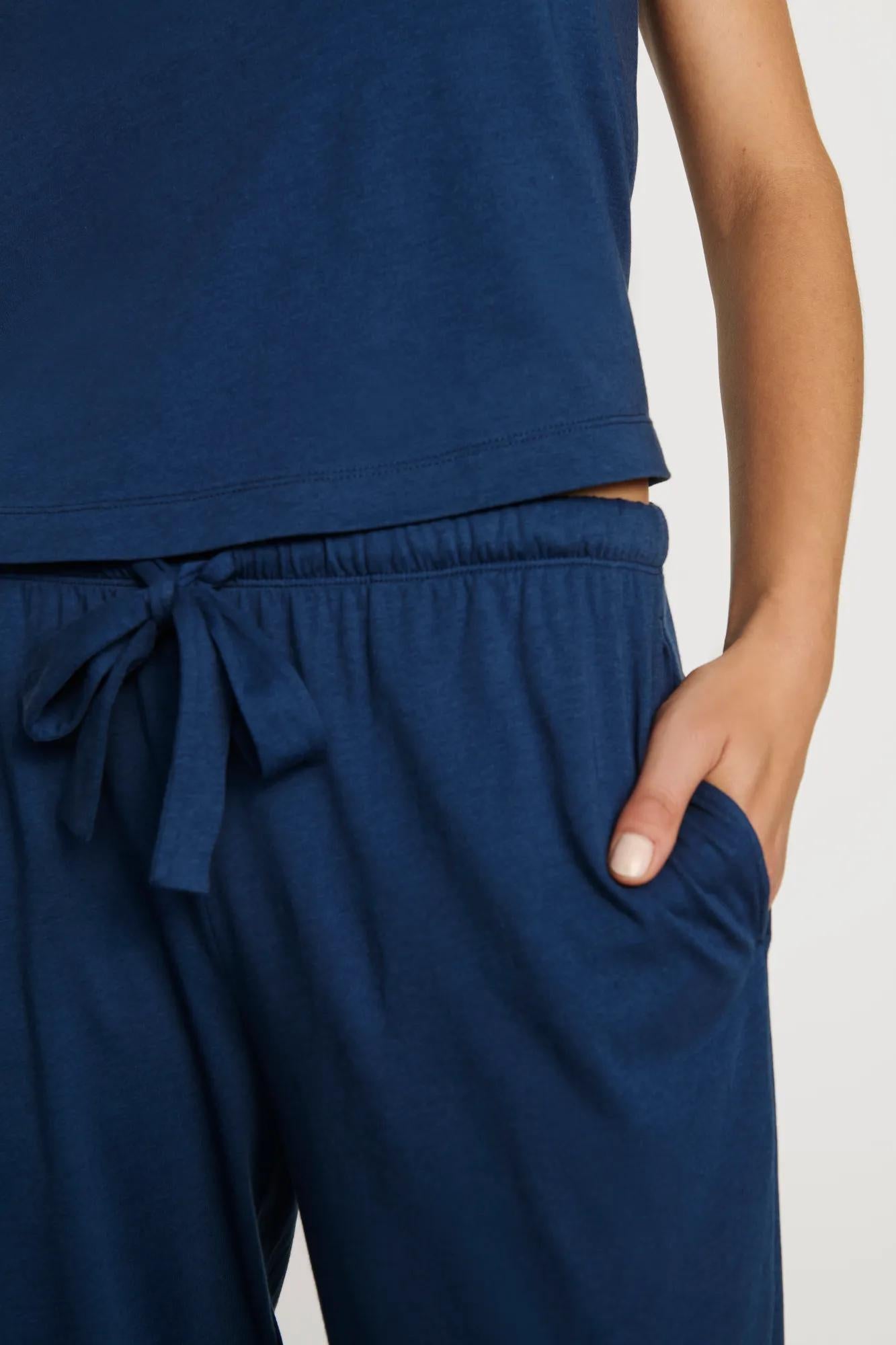 Model is wearing Aloe Cotton Pant in Navy