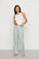 Model is wearing Nautico Boxer Pant in Regatta Stripe Seagrass/White